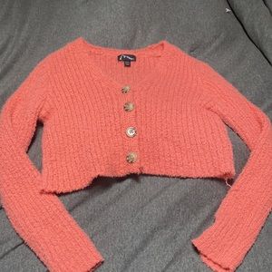 This is a crop top sweatshirt with buttons